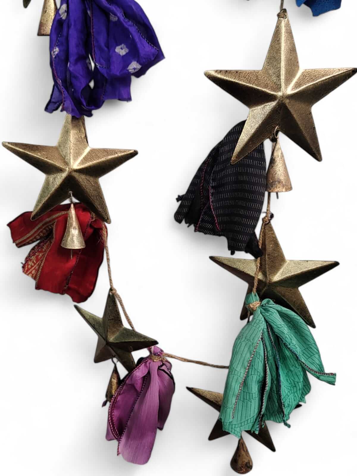 Handmade multicolour silk sari garland with metal stars and bells, perfect for bohemian holiday décor.