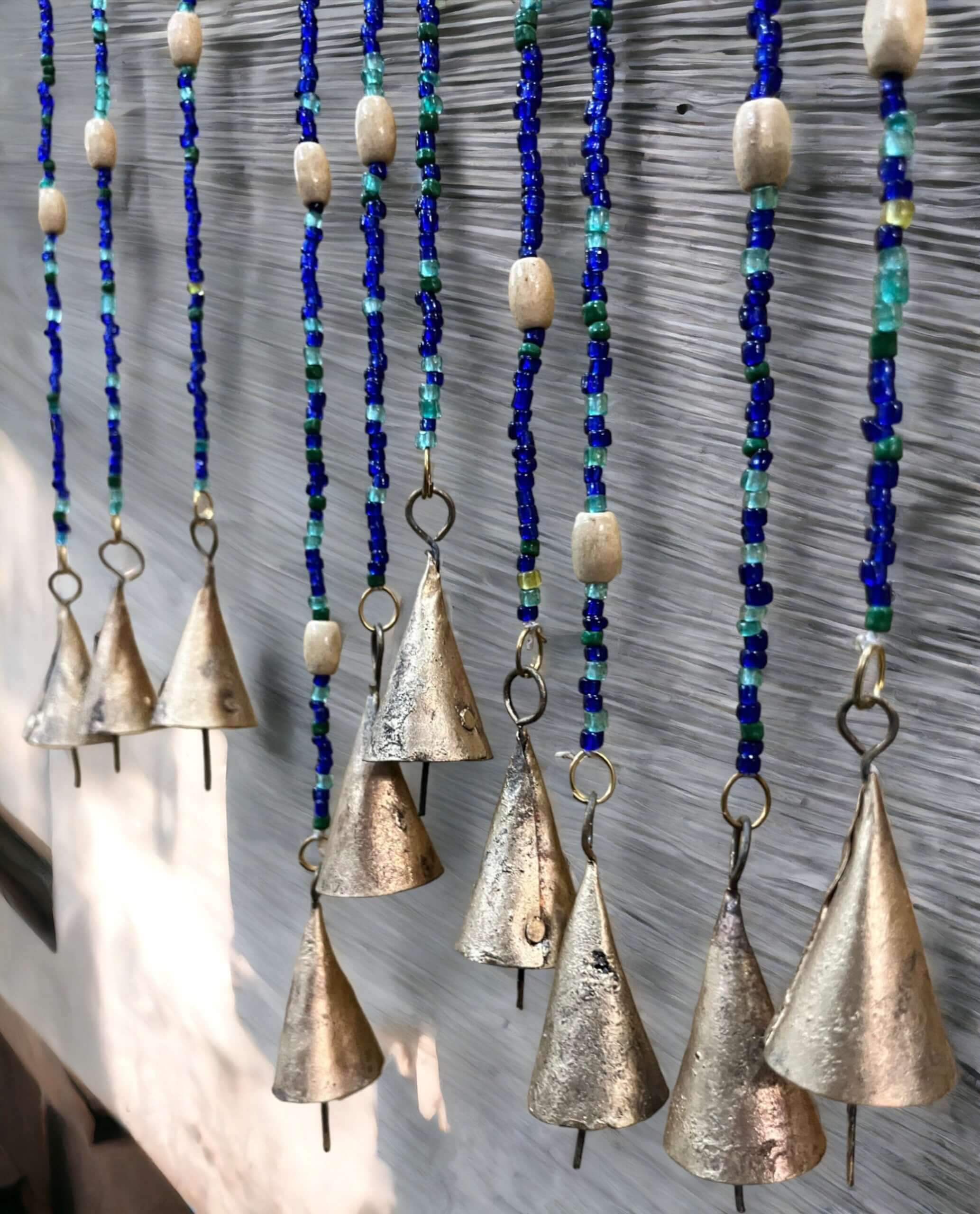 Handmade colorful glass bead strands with jingle bells—perfect for doorways or wall décor. Eco-friendly and crafted by women's artisans in India.