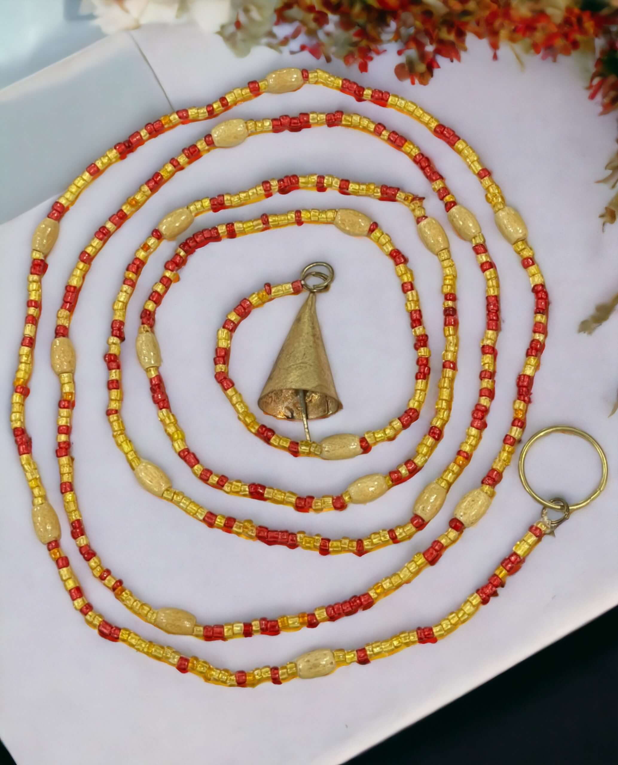 Handmade colorful glass bead strands with jingle bells—perfect for doorways or wall décor. Eco-friendly and crafted by women's artisans in India.