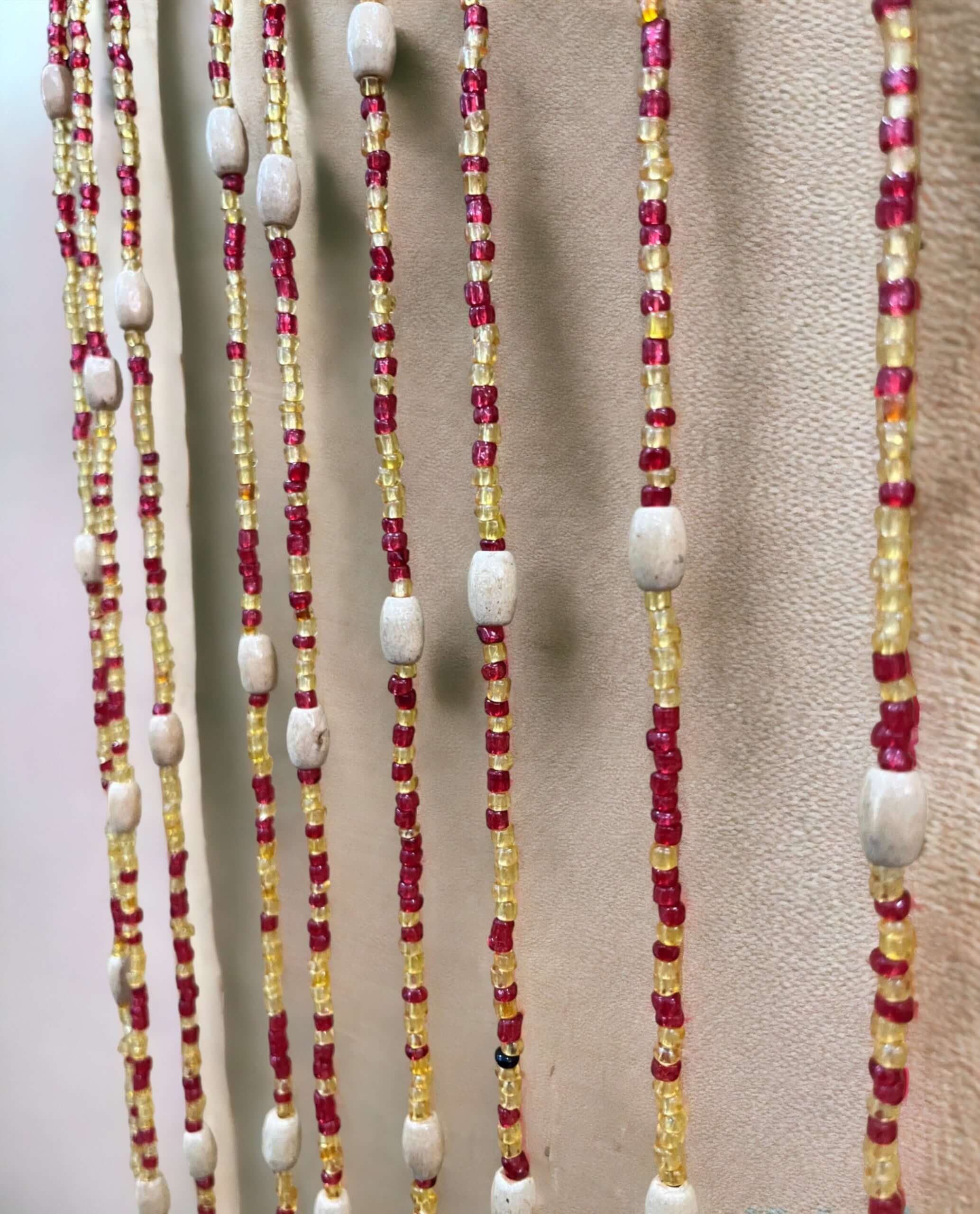 Handmade colorful glass bead strands with jingle bells—perfect for doorways or wall décor. Eco-friendly and crafted by women's artisans in India.
