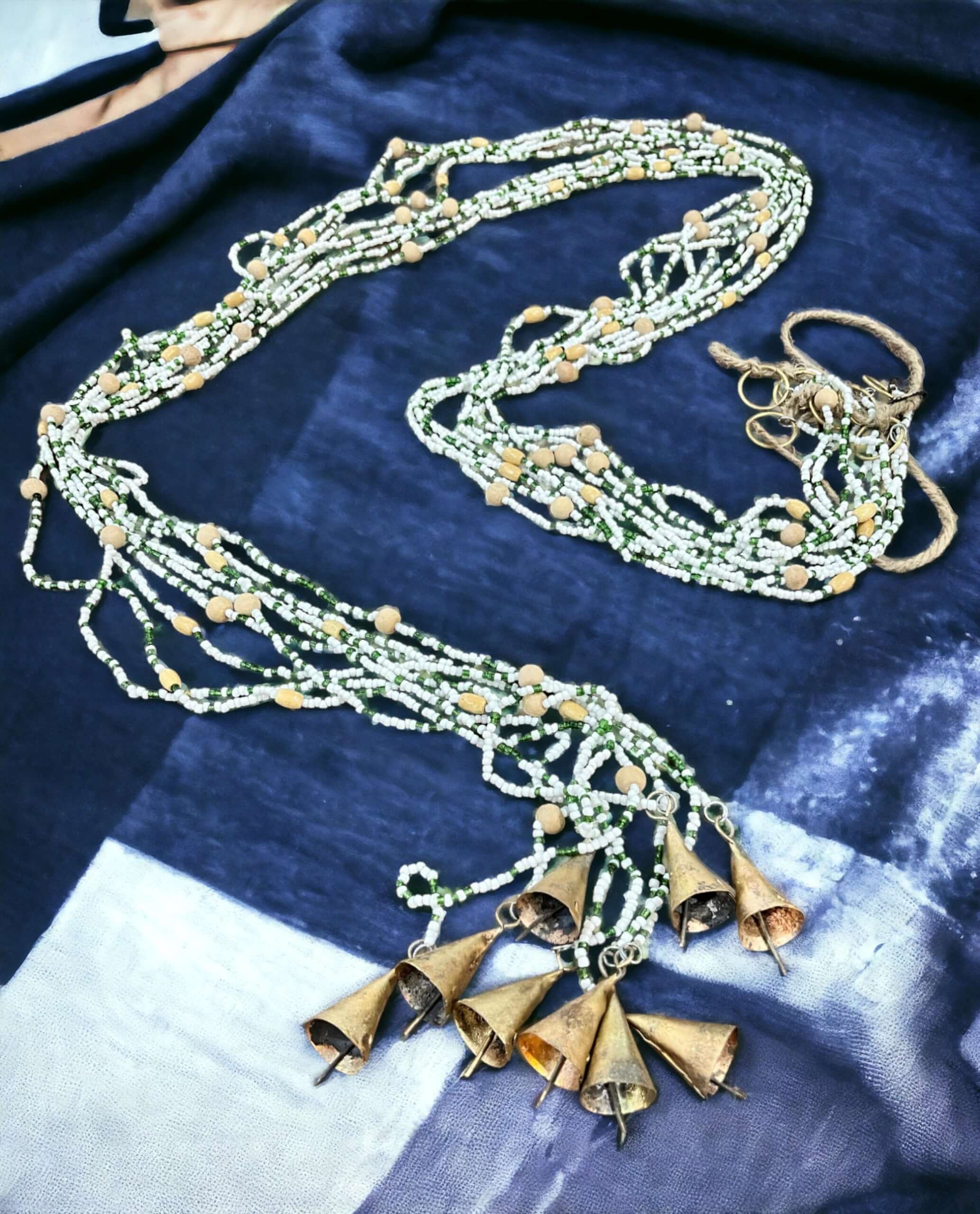 Handmade colorful glass bead strands with jingle bells—perfect for doorways or wall décor. Eco-friendly and crafted by women's artisans in India.