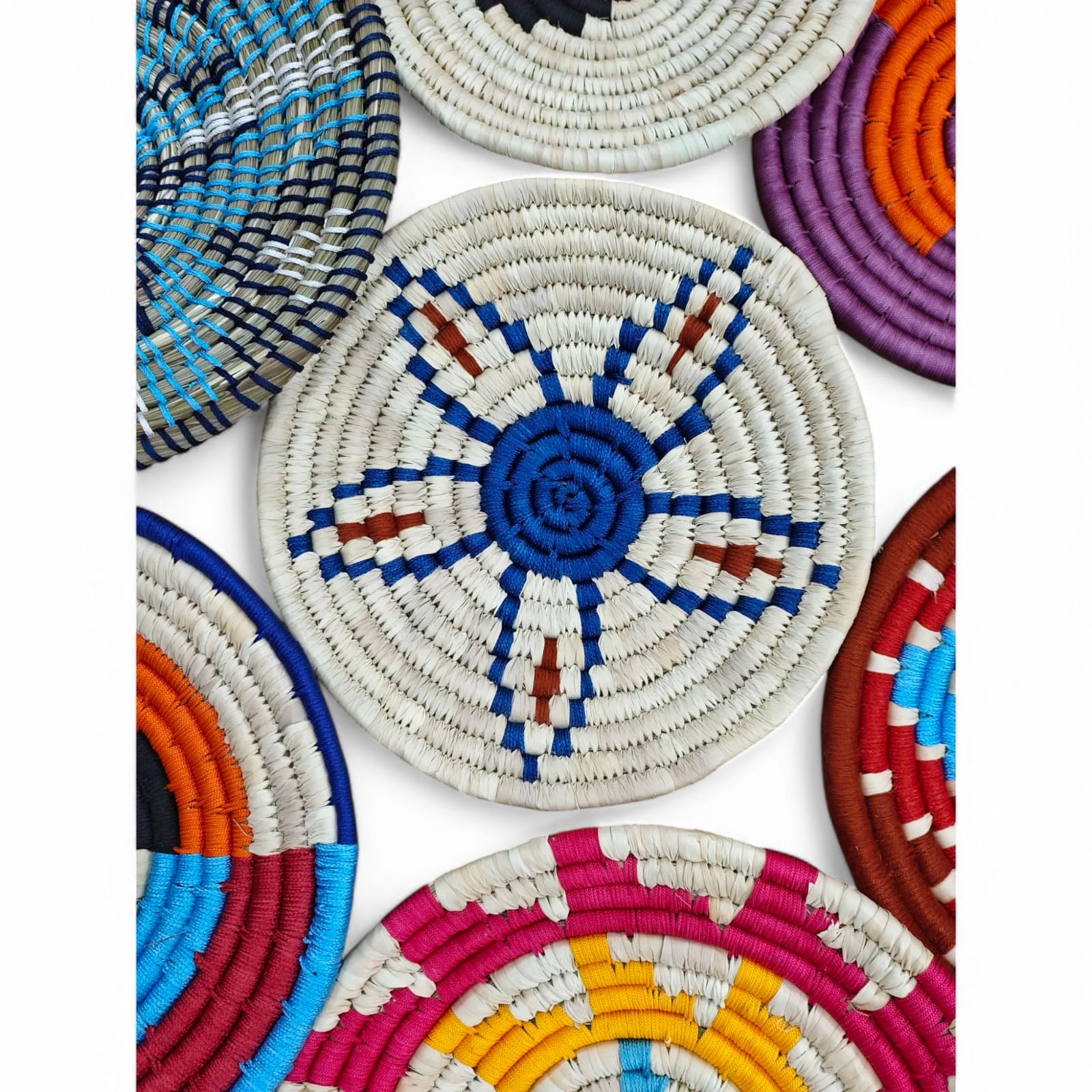 Colorful handmade Sabai grass wall baskets, featuring intricate patterns, perfect for boho wall decor and unique wall art.