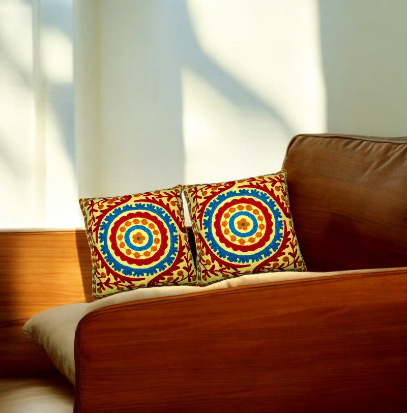 Set of 2 multicolor Boho mandala cushion covers on a stylish couch, adding vibrant decor to living space.