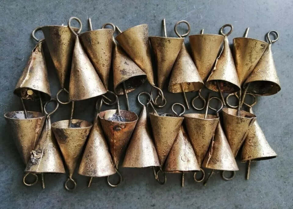 Rustic cone-shaped recycled iron bells in golden finish, handmade, ideal for crafts or decorative use.