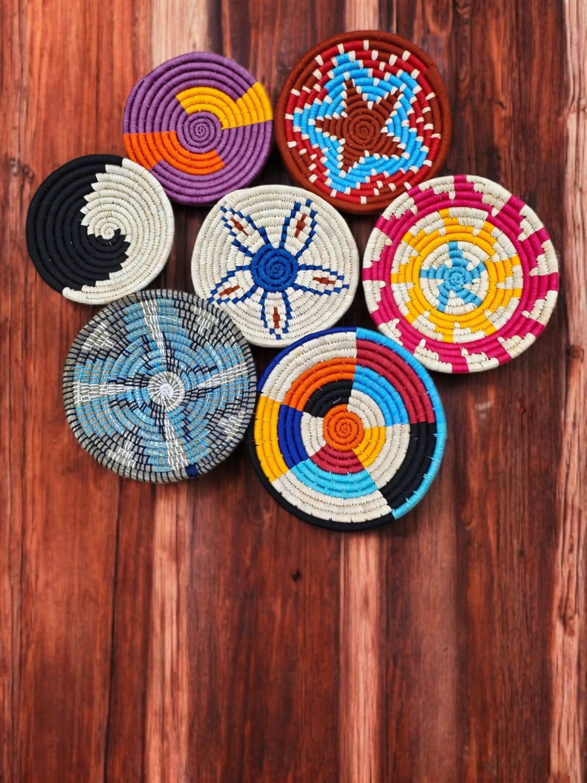 Handwoven multicolor Sabai grass wall baskets set of 7 for boho wall art and decor.