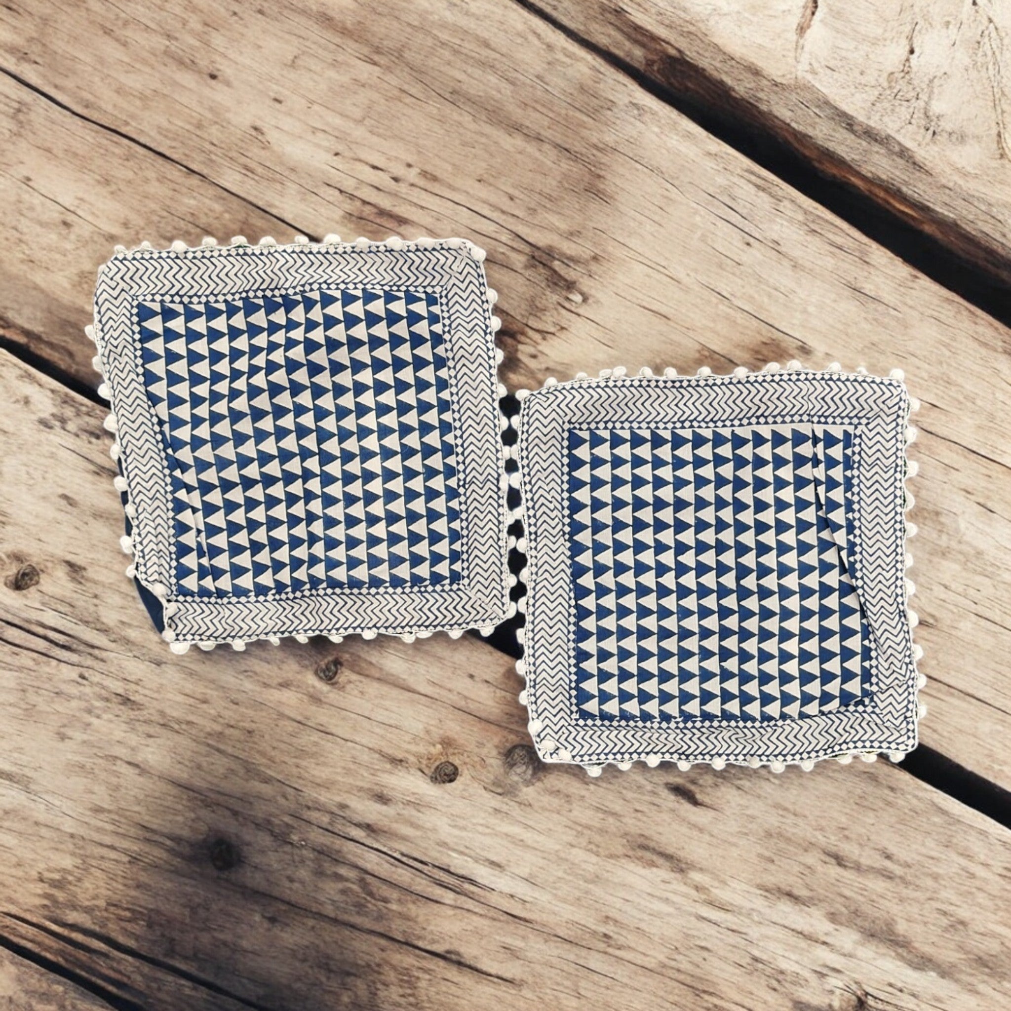 Set of 2 blue and white geometric cushion covers with decorative fringe, perfect for modern home decor.