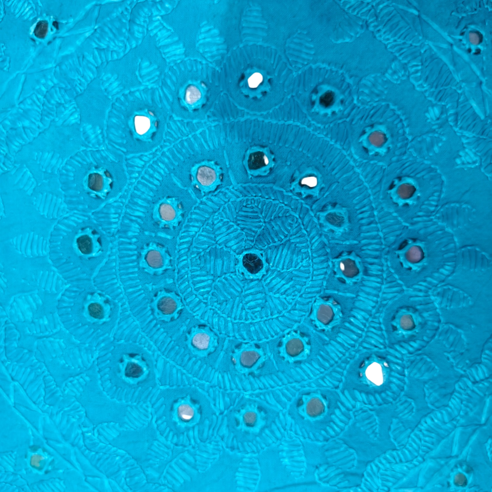 Turquoise blue cushion cover featuring intricate handcrafted mirror work and embroidery design.