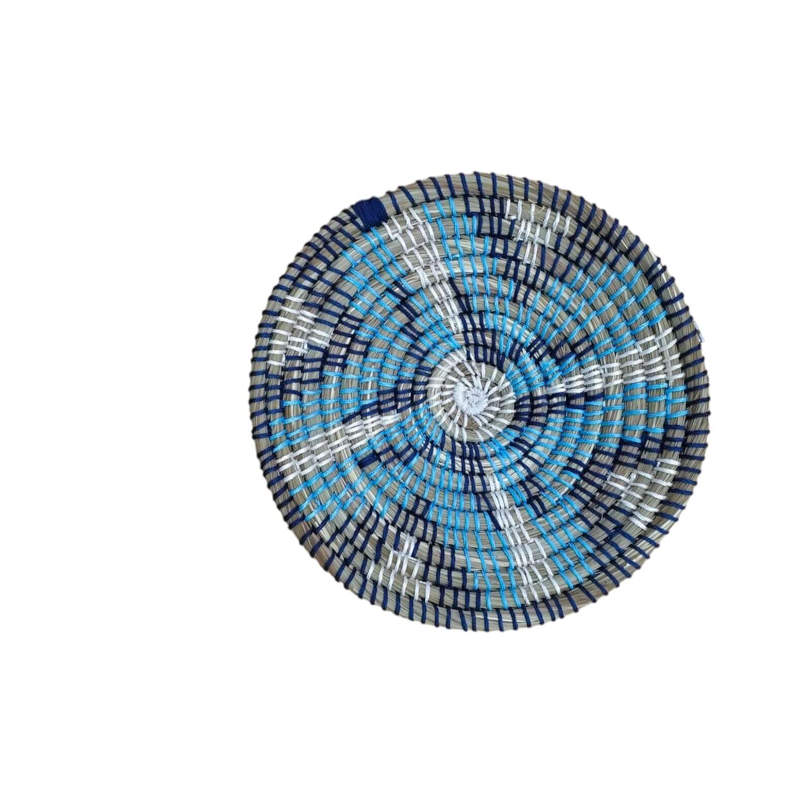 Handwoven round rattan wall basket in shades of blue, perfect for boho wall décor and wall art.