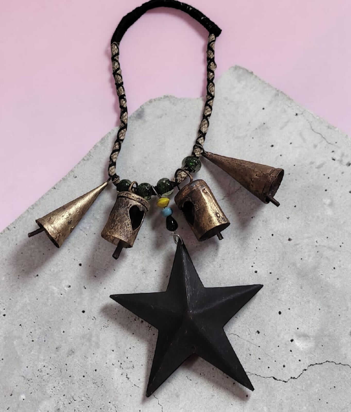 Rustic Christmas bells handcrafted with tin, metal stars, and a jute design, perfect for holiday decorations.