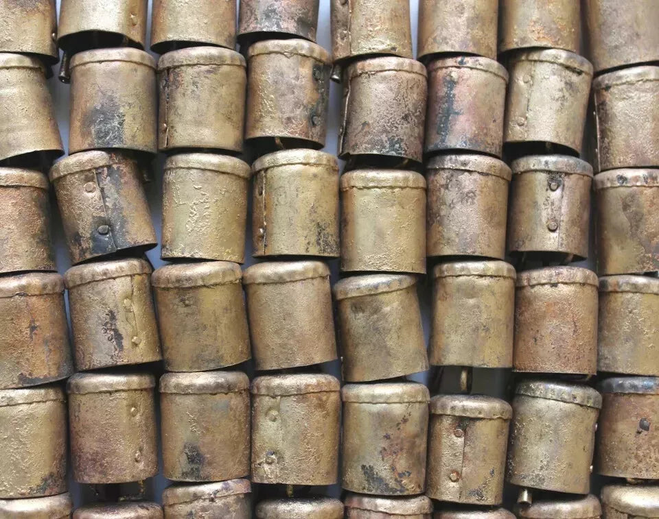 Handmade Indian cowbells, 2" height, crafted from recycled iron with a rustic brass finish. Unique variations in design.