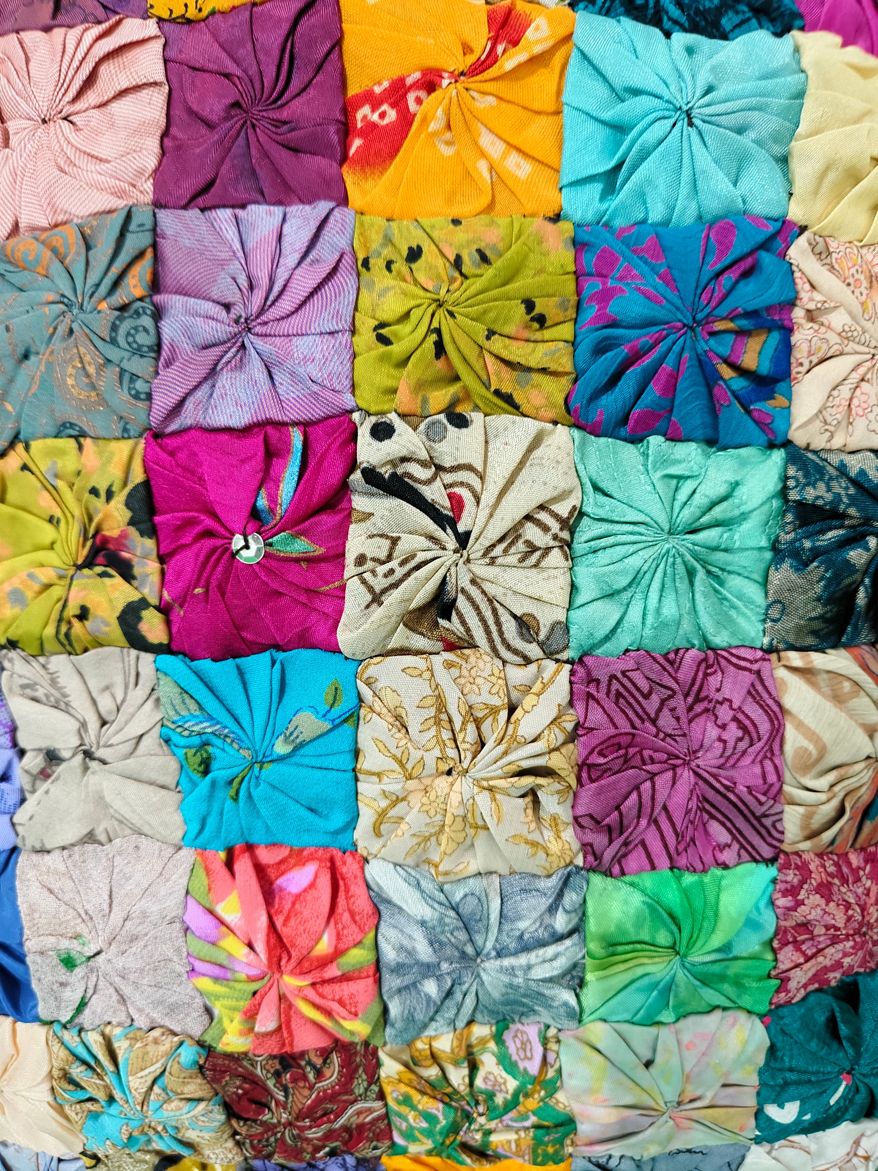 Colorful patchwork cushion cover featuring diverse fabric squares, perfect for vibrant home decor.
