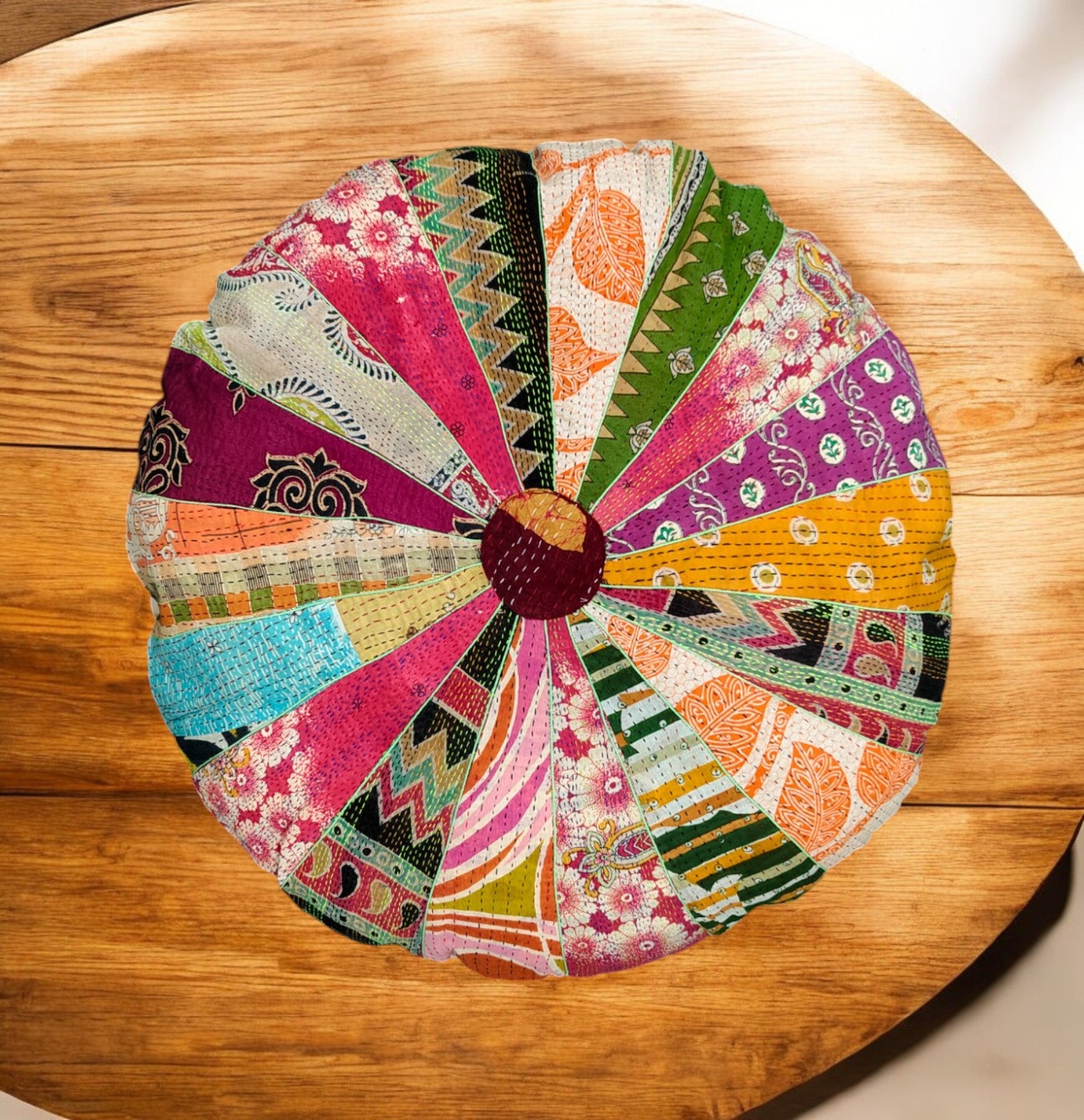 Round multicolor patchwork floor cushion cover with Kantha design on wooden table, 28"x5" inch