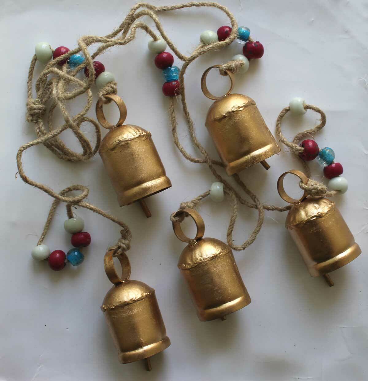 Hanging antique look rustic bells garland with colorful beads, perfect for garden decor and outdoor relaxation.