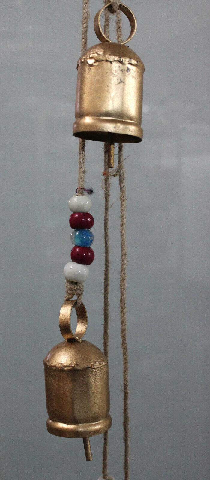 Antique look hanging bells decor with colorful glass beads, perfect as rustic garden ornament or vintage wind chimes.