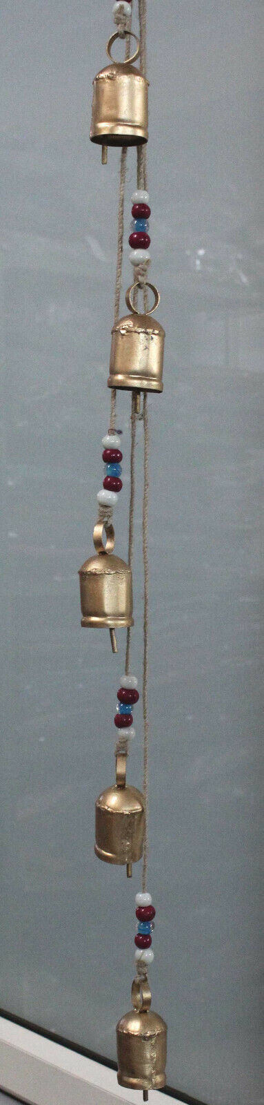 Hanging antique wind chime with metal bells and glass beads, perfect for outdoor decor and relaxation in gardens.