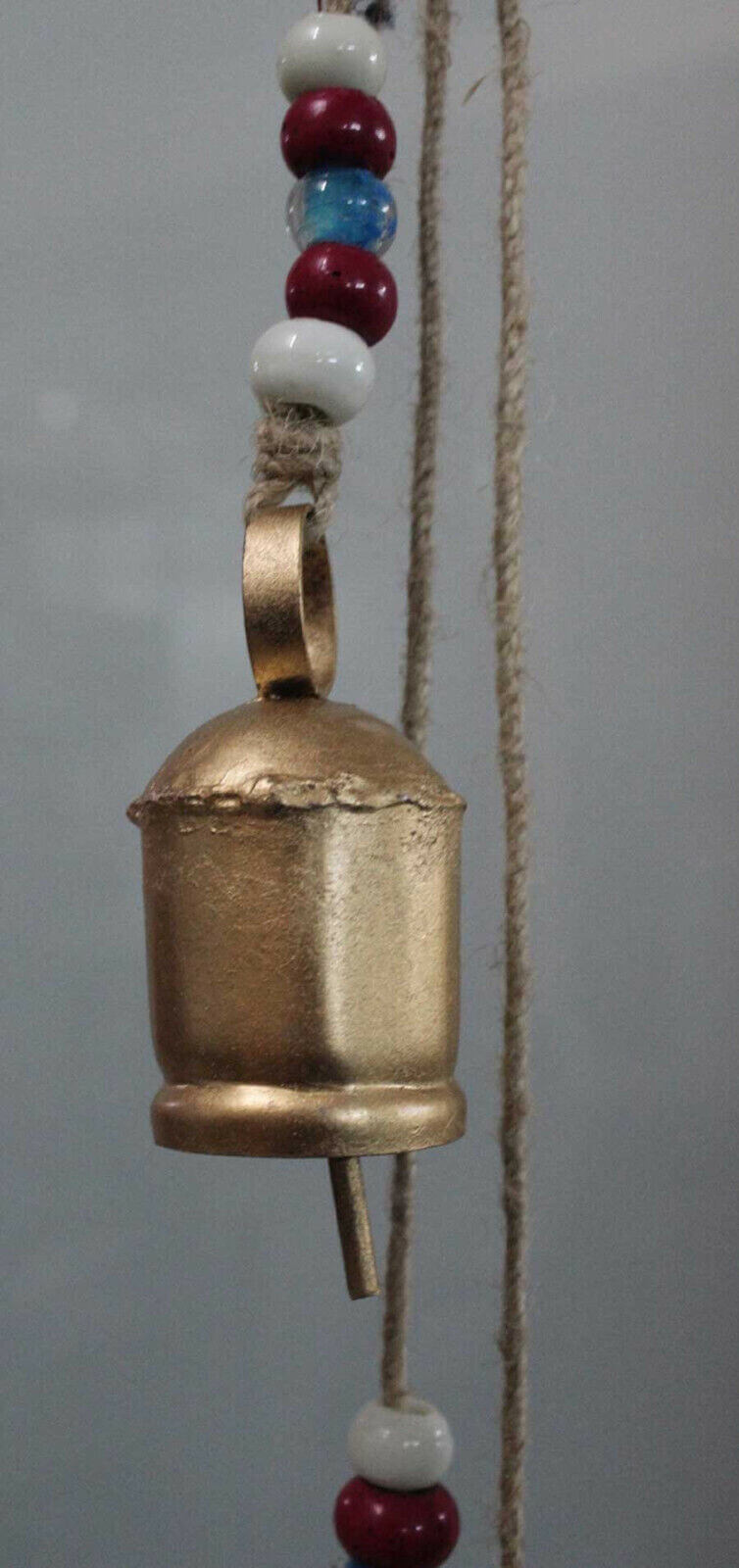 Antique look wind chime bell with colorful beads, perfect for garden relaxation and decoration.