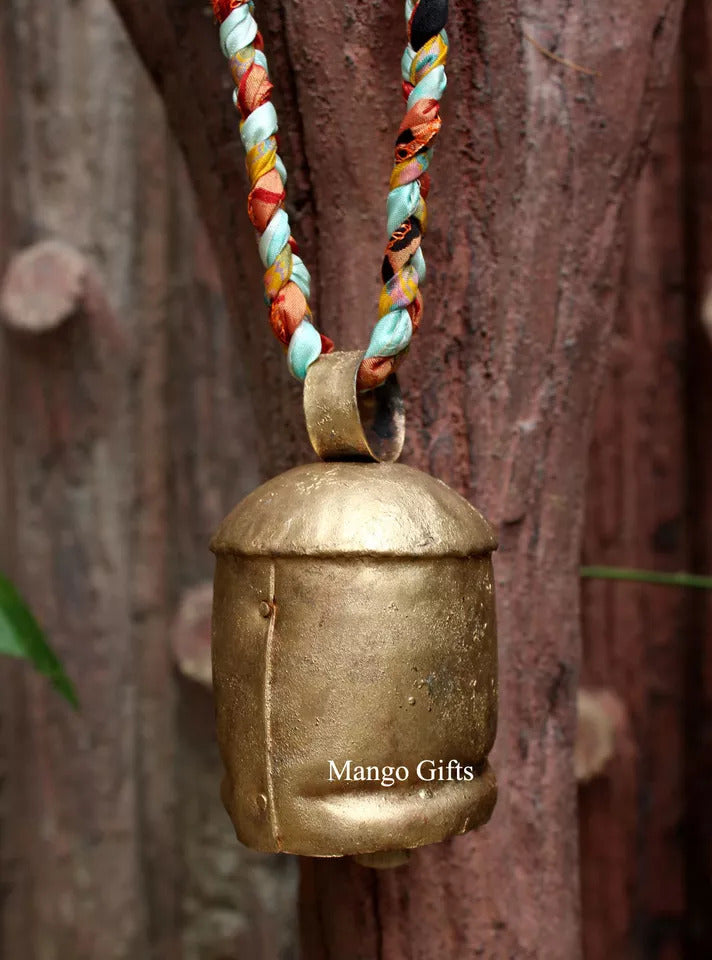 Handcrafted recycled iron bell with a colorful braided rope, perfect for home and garden decor.