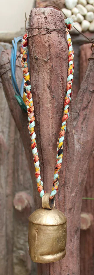 Handcrafted recycled iron bell with colorful braided rope, perfect for home and garden décor.