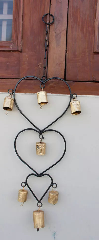 Beautiful handcrafted wind chime made from recycled iron, featuring gold bells. Perfect for home décor or as a thoughtful gift.