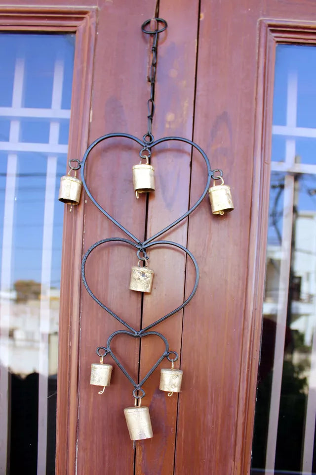 Beautiful handcrafted wind chime made from recycled iron, featuring gold bells. Perfect for home décor or as a thoughtful gift.