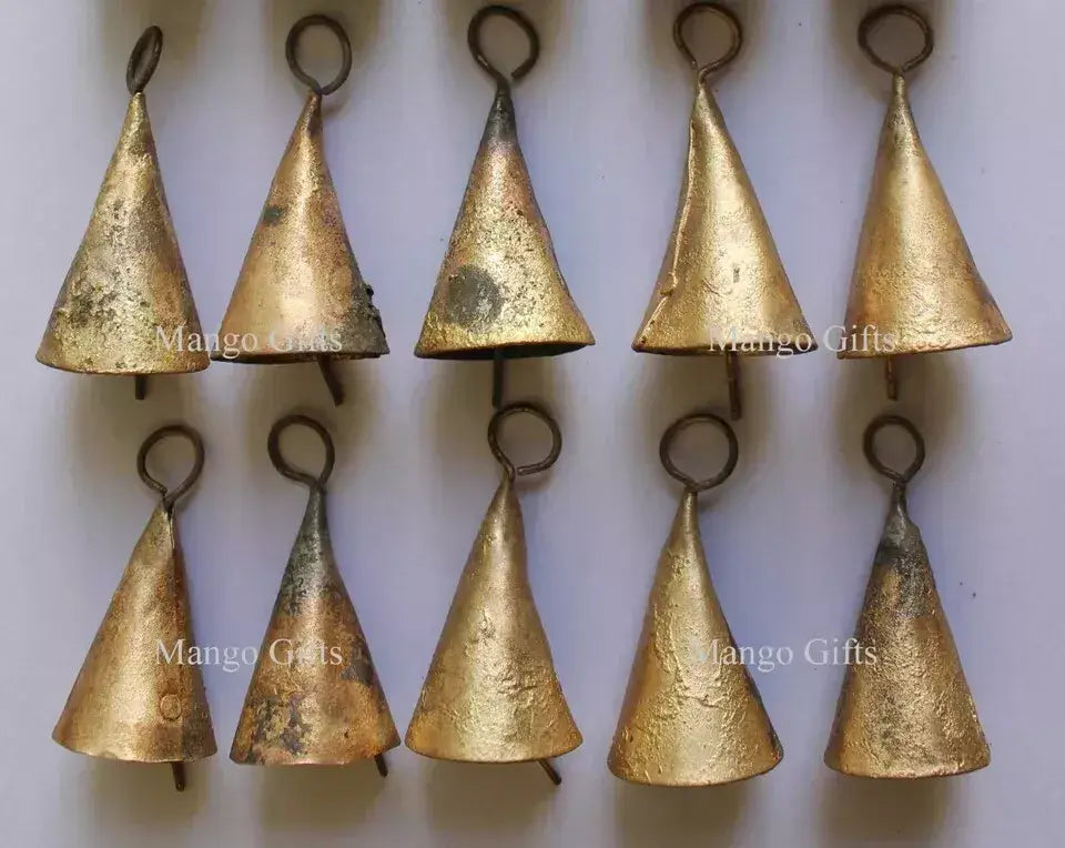 Rustic cone-shaped antique cow bells in gold finish, ideal for crafts, decor, and outdoor hanging mobiles.