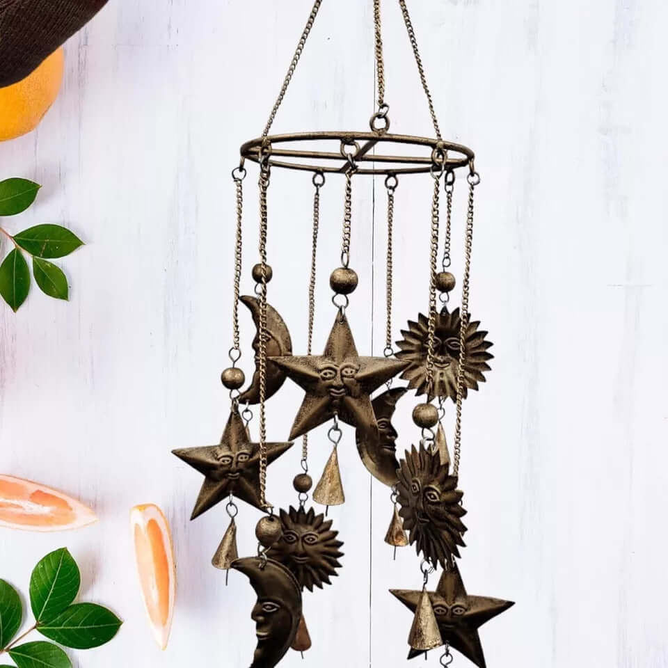 Antique sun and moon wind chime with rustic bells, perfect for outdoor patios and gardens.