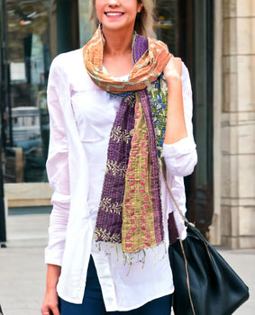 Vintage Kantha 100% cotton reversible scarf in vibrant colors, worn stylishly with a white shirt and black bag.