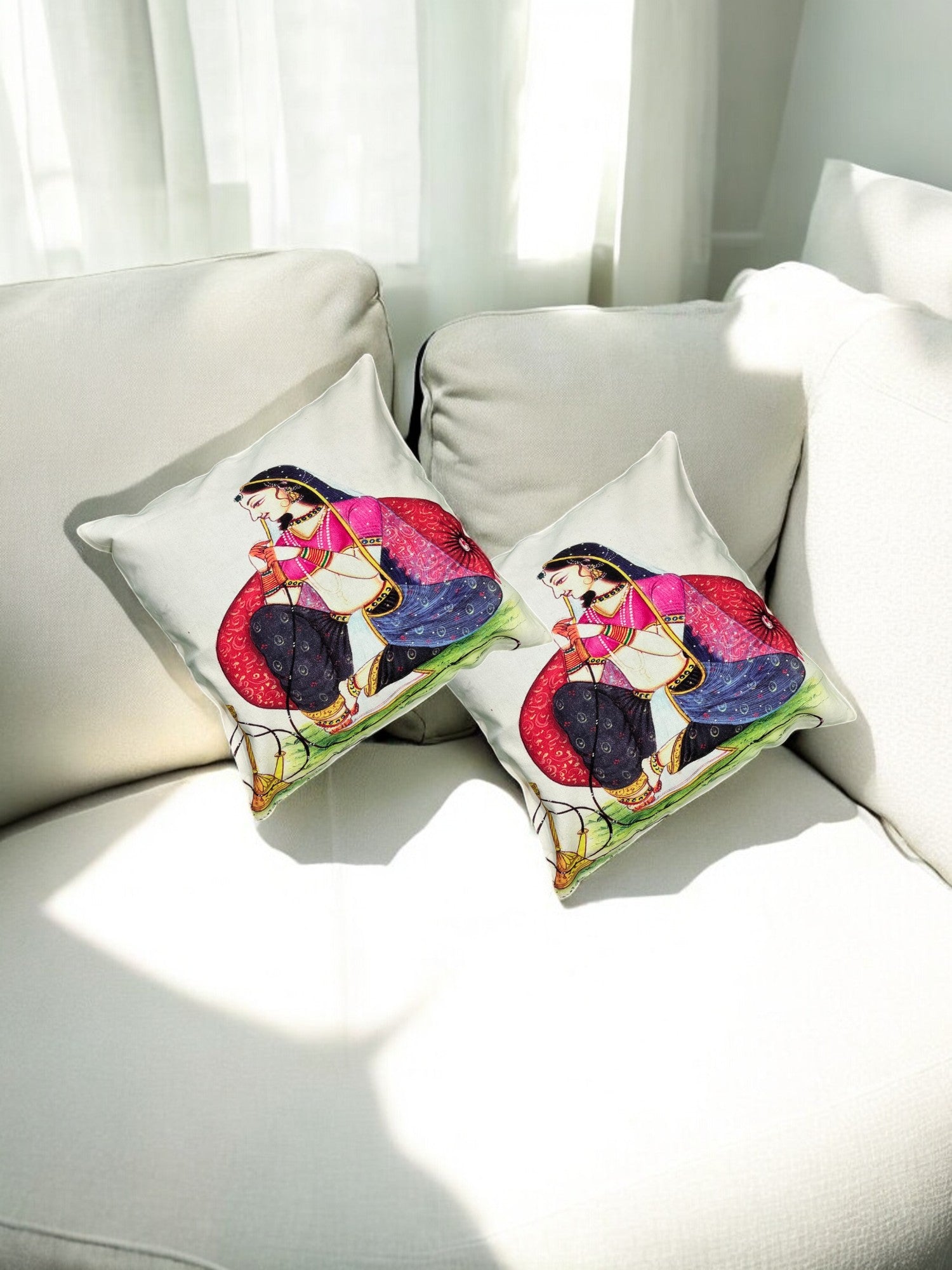Set of 2 Traditional Rajasthani lady digital print cushion covers on a sofa, adding a vibrant decorative touch.