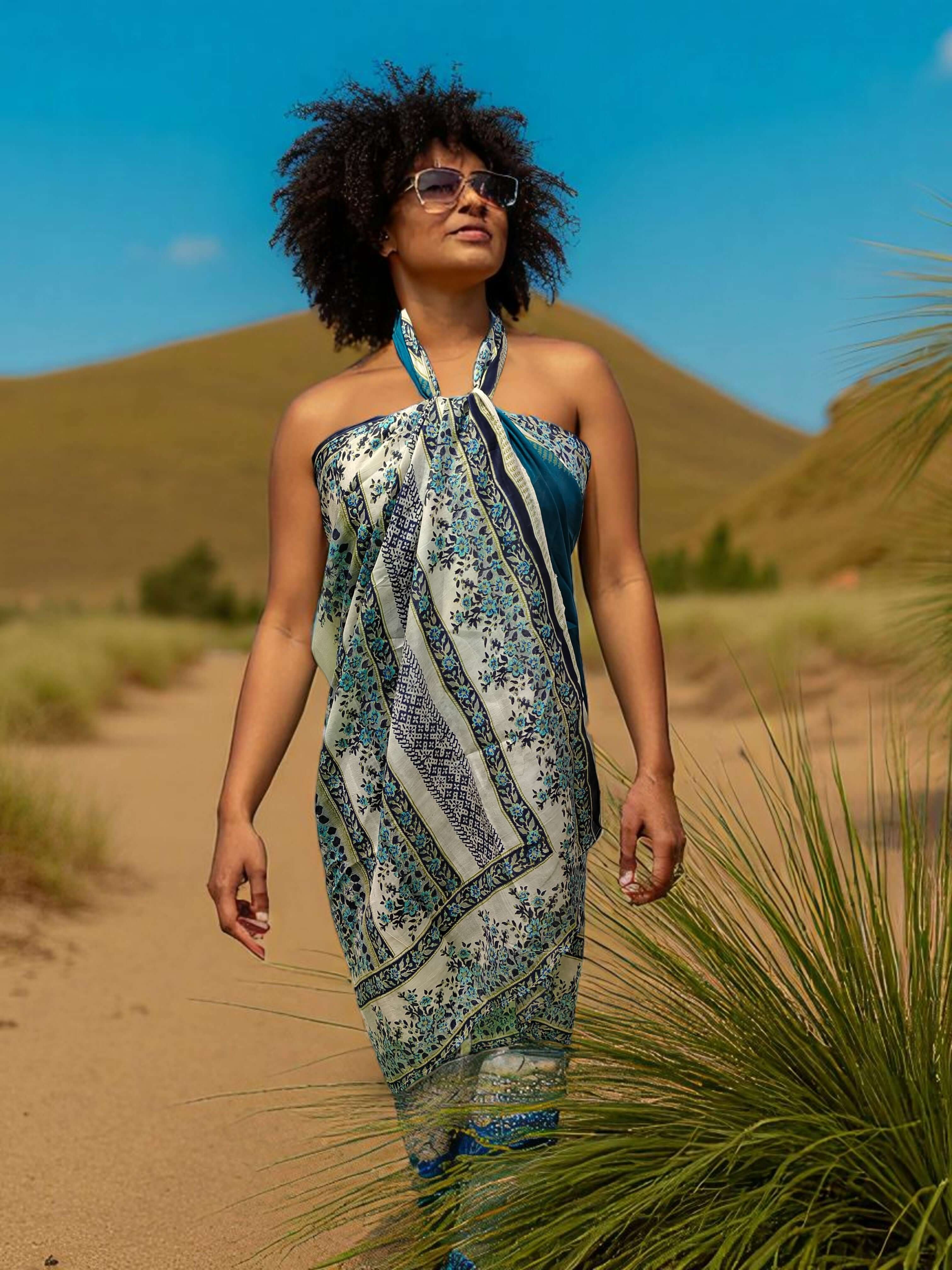 Silk Sari Saree scarf worn as a beach wrap by a woman in sunglasses, showcasing floral print in a scenic outdoor setting.