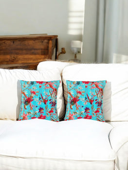 Set of 2 Turquoise Floral Kantha Cushion Covers on a white sofa, adding a pop of color and style.
