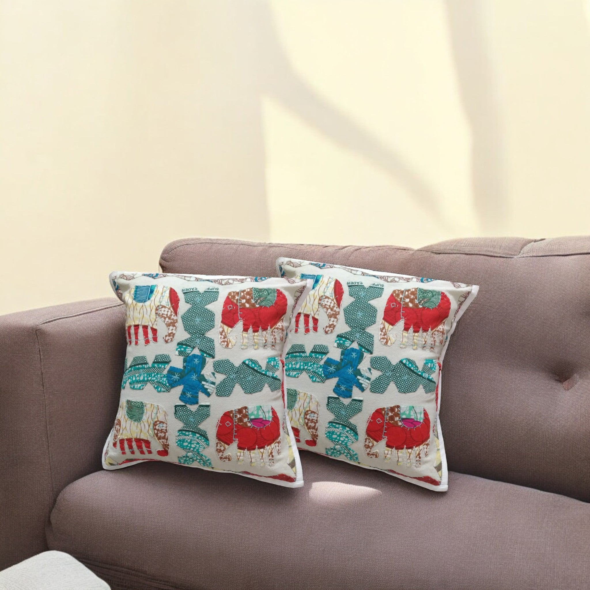 Vibrant elephant decorative throw pillow covers set of 2 on sofa, multicolor handmade cushion accent for home decor.