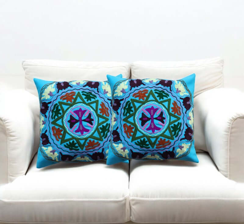 Peacock Floral Cushion Covers Set of 2 displayed on a white sofa, 16x16 inches, featuring vibrant, intricate designs.