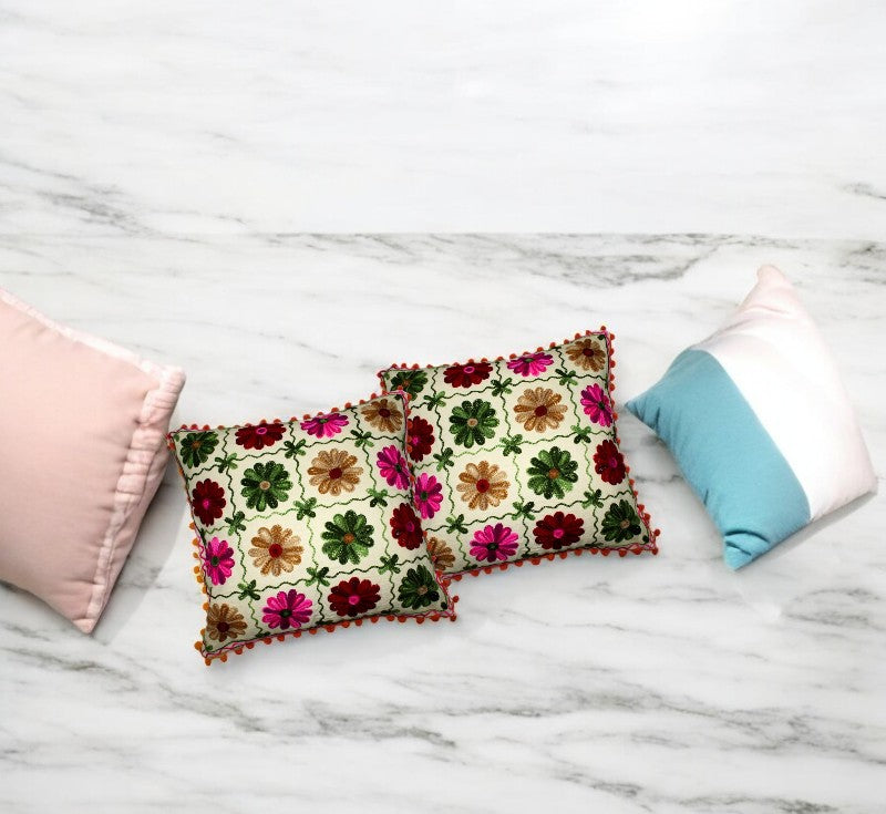 Set of 2 vibrant multicolor Indian patchwork cushion covers on a marble surface, perfect for decorative pillows.