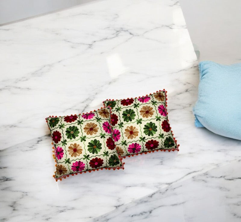 Vibrant multi-color Indian patchwork cushion covers on a marble surface, perfect for sofa or bed decor.