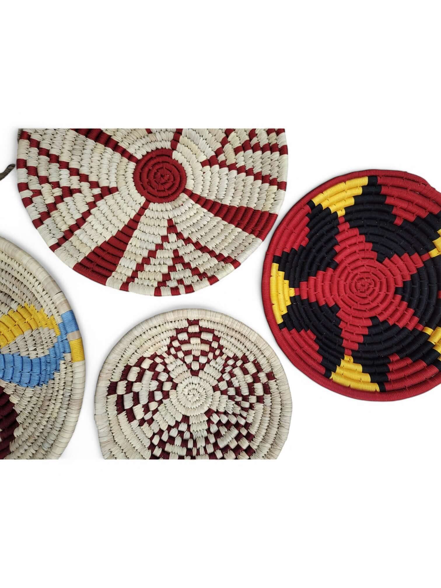 Colorful handmade Sabai grass wall baskets in geometric patterns, perfect for bohemian home decor.