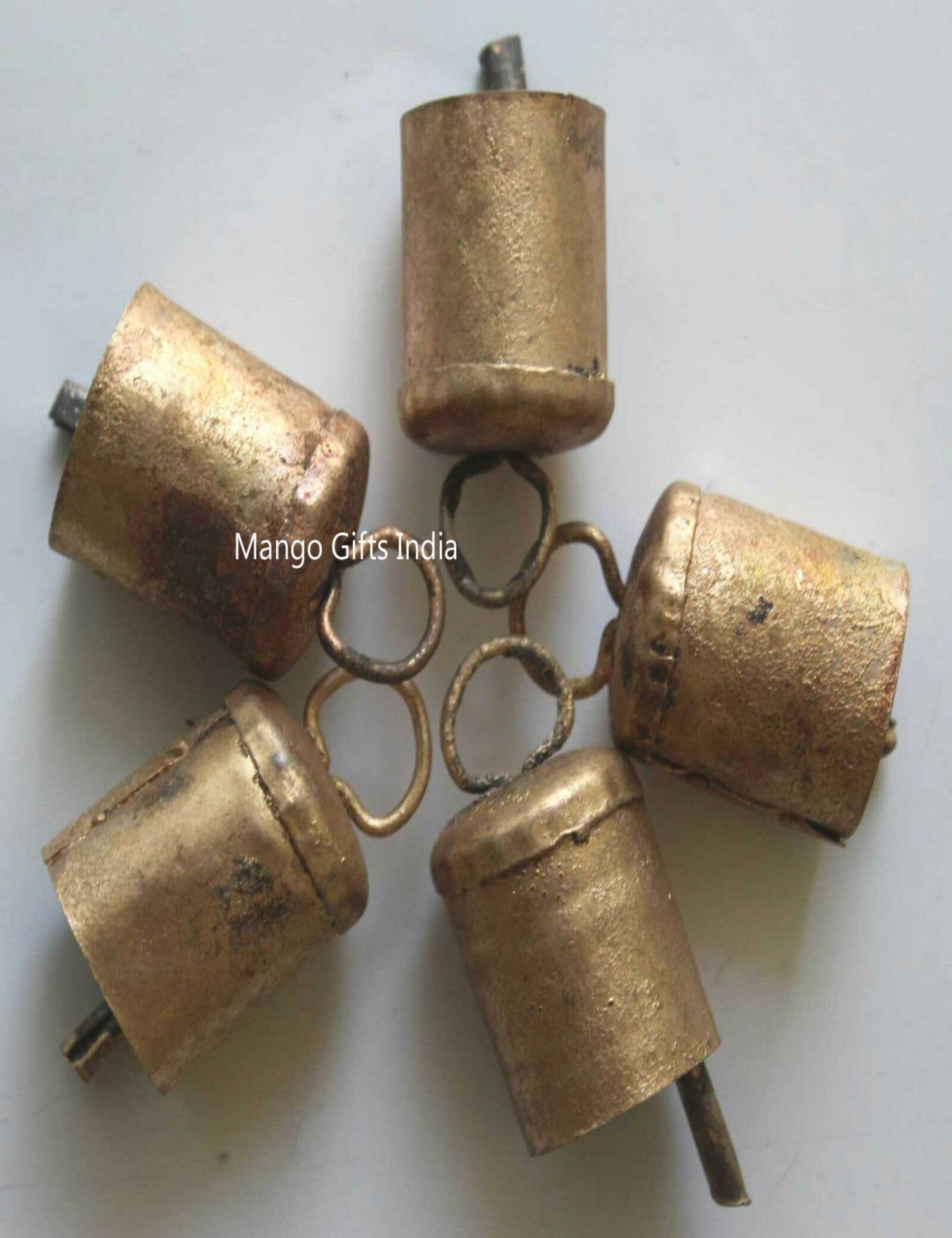 Handmade Indian cow bells in rustic golden color, made from recycled iron, featuring a unique rough finish.