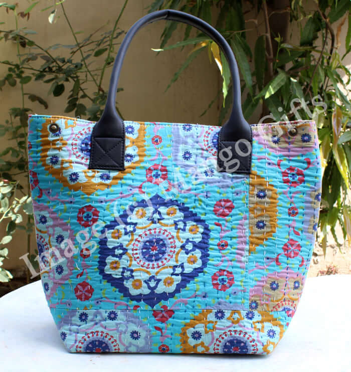 Colorful blue Kantha tote bag with intricate patterns and black handles, perfect for stylish carrying.