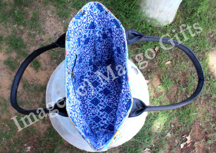 Inside view of a stylish blue Kantha tote bag with black handles, showcasing intricate patterns.