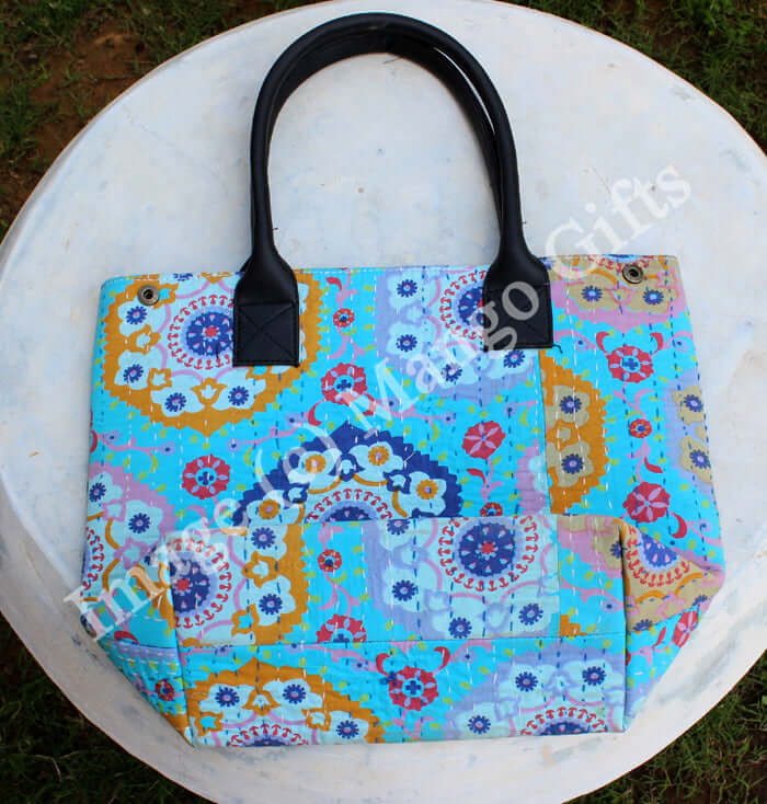 Colorful blue Kantha tote bag with intricate patterns and sturdy black handles, perfect for stylish shopping.