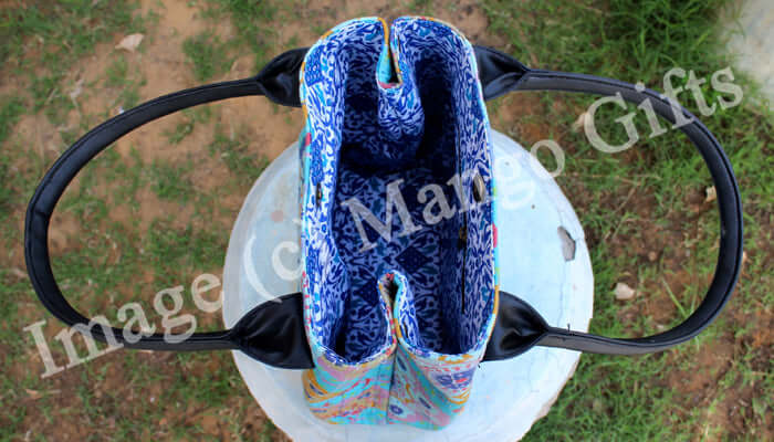 Top view of a vibrant blue Kantha tote bag showcasing its unique design and sturdy handles.