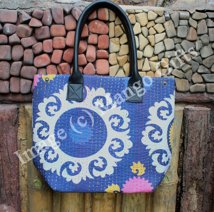 Handmade blue cotton Kantha tote bag with floral design and leather straps, perfect for shopping and picnics.