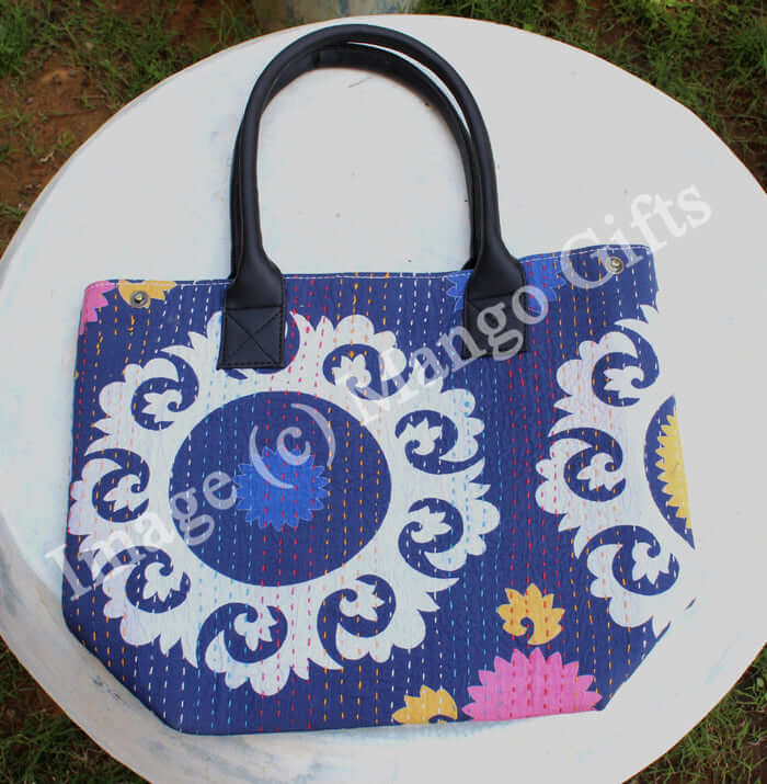 Handmade blue cotton Kantha tote bag with leather straps, perfect for shopping or picnics, featuring vibrant floral design.