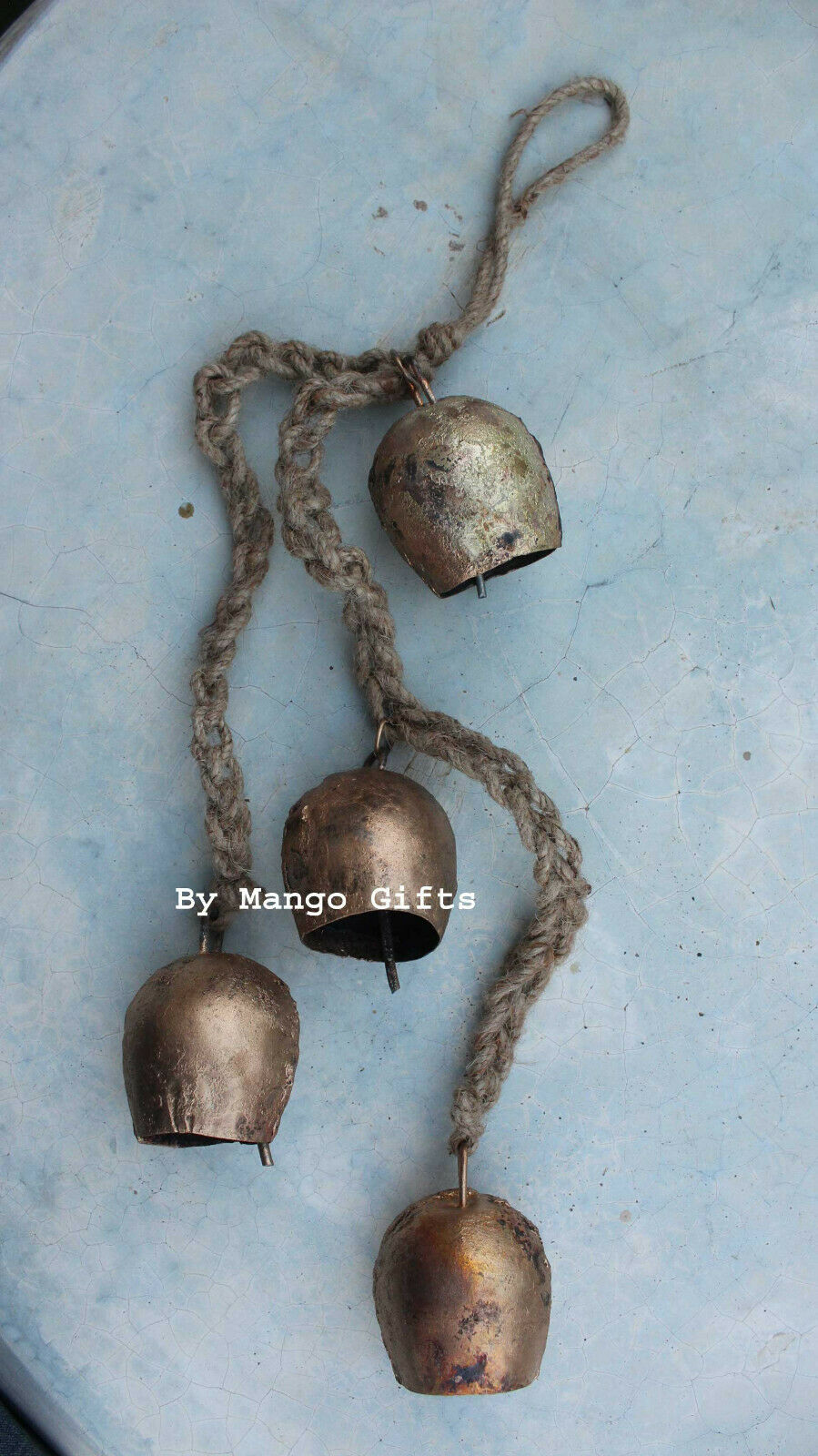 Transform your garden with these shabby chic wind chimes! Handmade tin bells on jute rope, perfect for wholesale décor lovers.