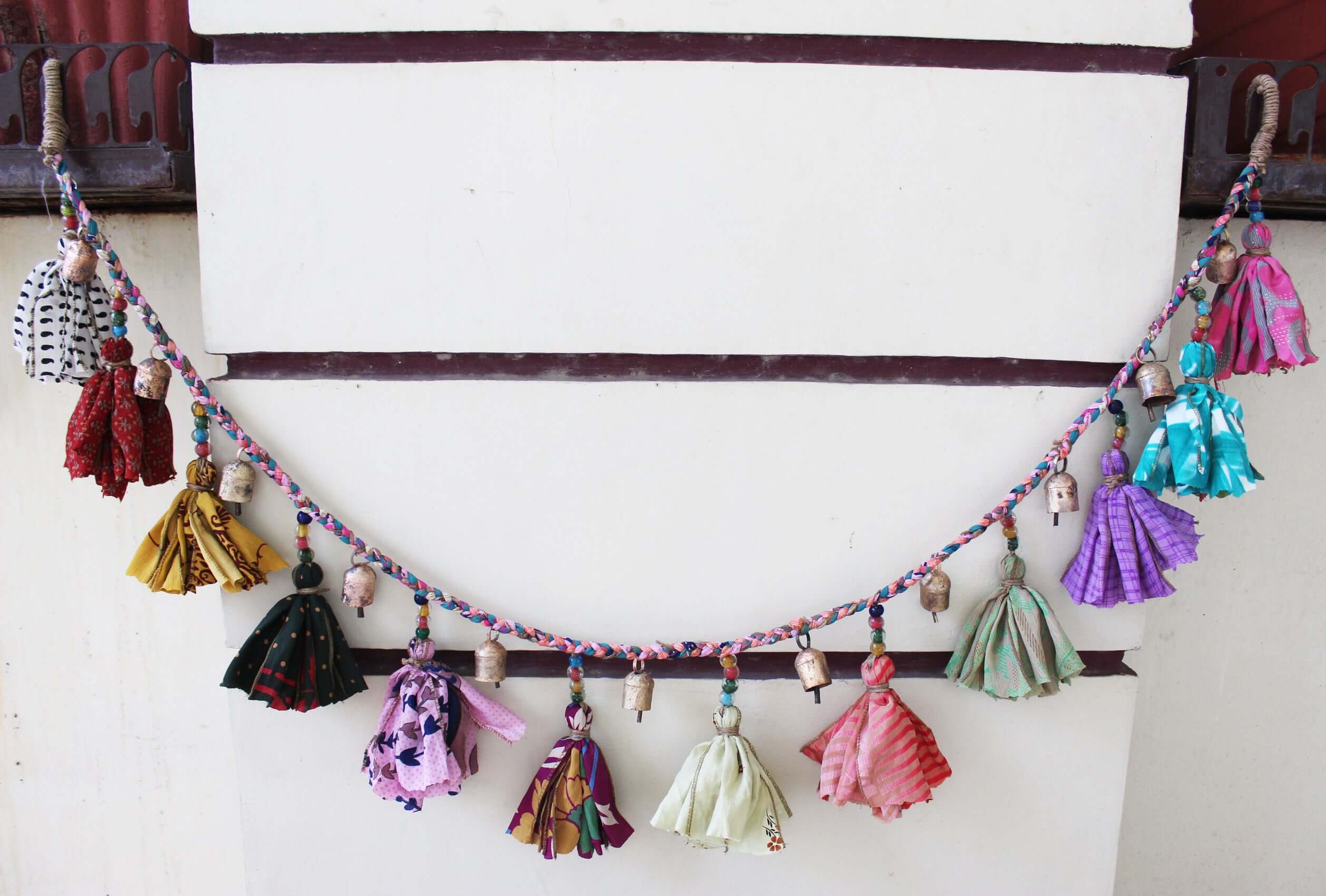 Adorn your space with this 5ft handmade garland of brass bells and glass beads. Perfect for parties and home decoration.