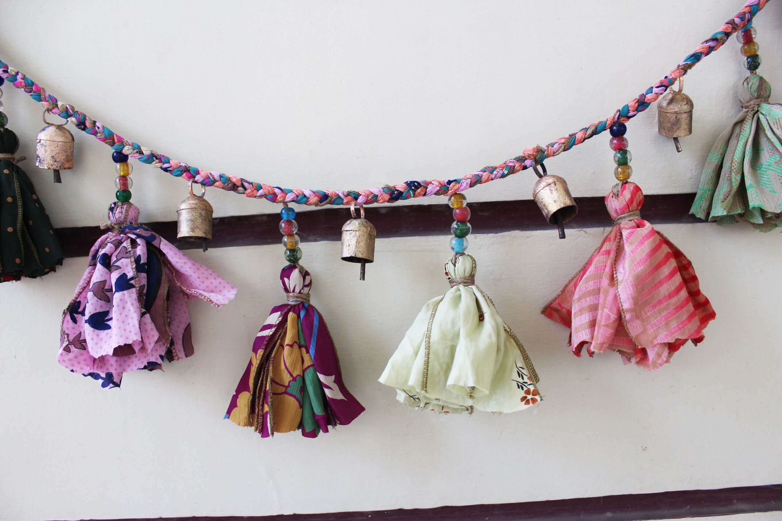 Adorn your space with this 5ft handmade garland of brass bells and glass beads. Perfect for parties and home decoration.