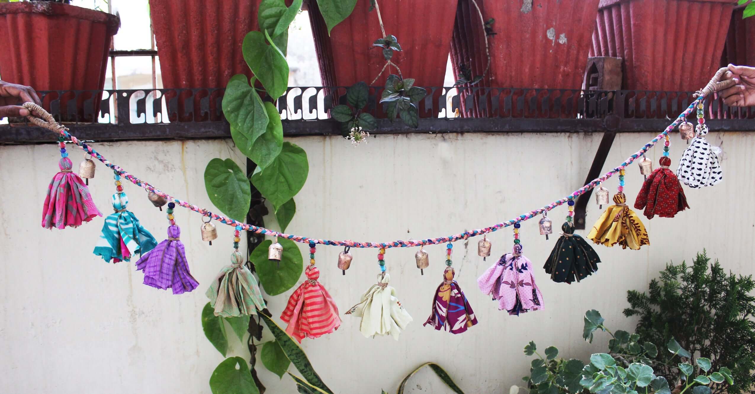 Adorn your space with this 5ft handmade garland of brass bells and glass beads. Perfect for parties and home decoration.