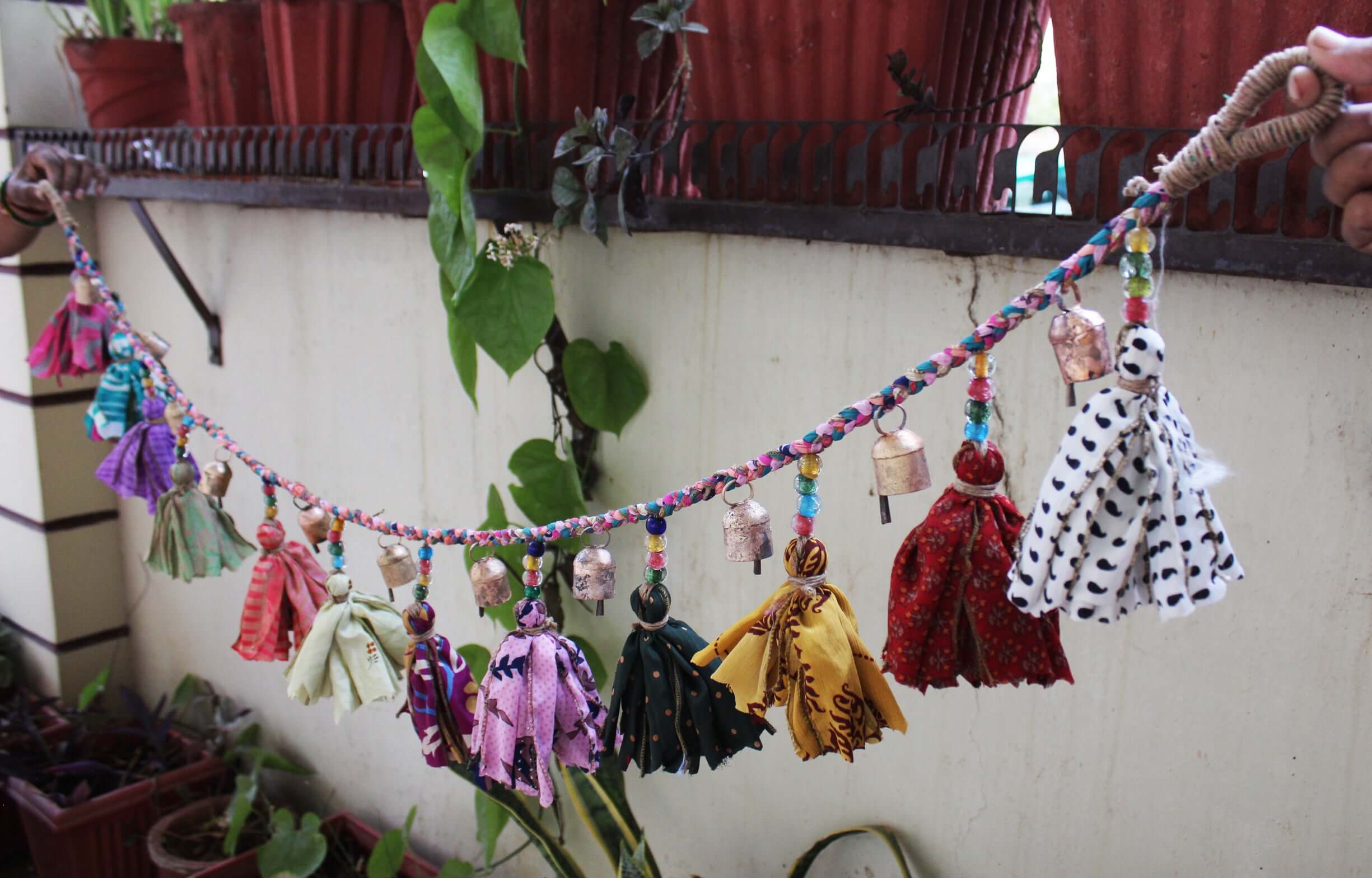 Adorn your space with this 5ft handmade garland of brass bells and glass beads. Perfect for parties and home decoration.