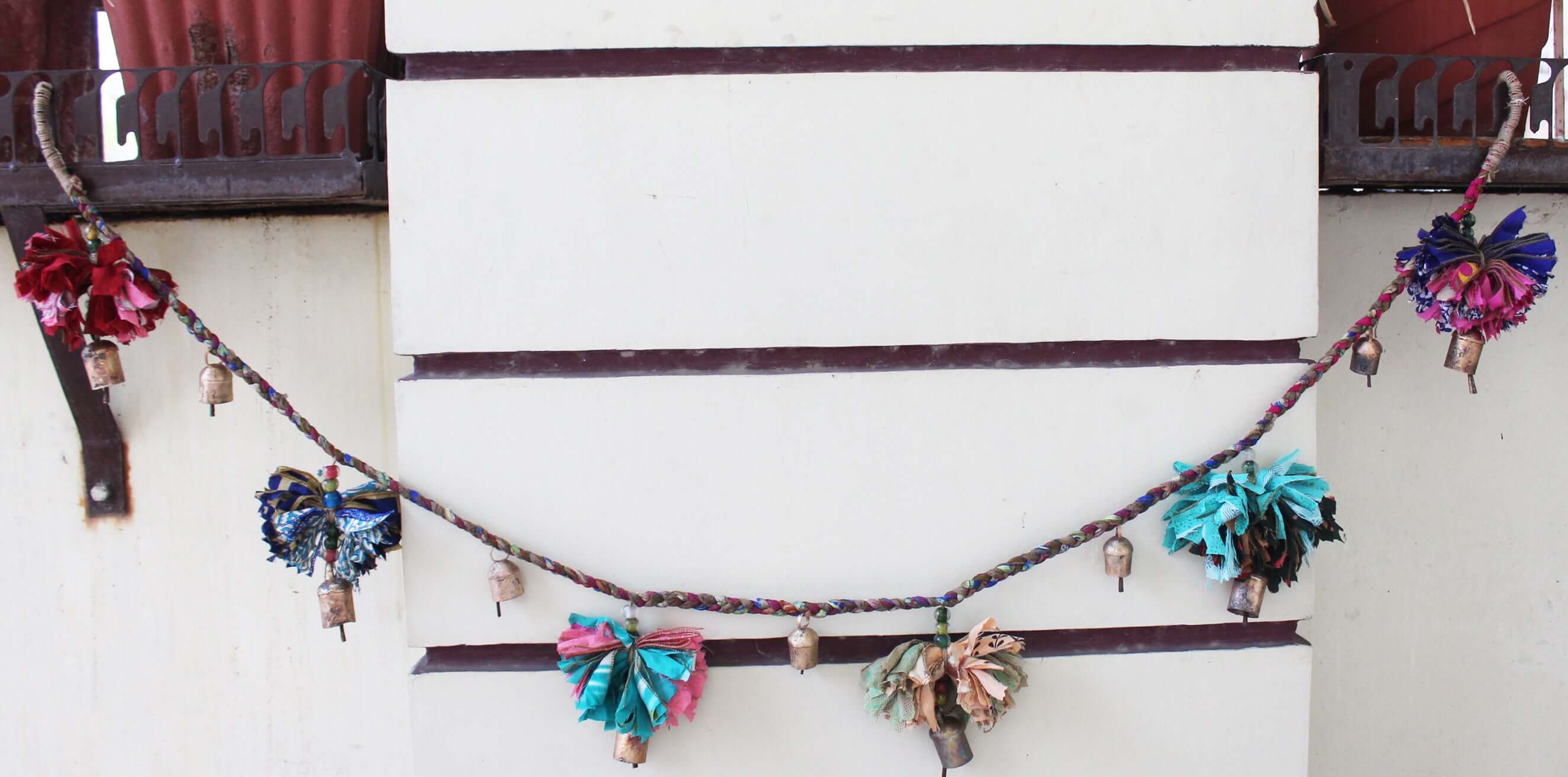 Adorn your space with this 5ft handmade garland of brass bells and glass beads. Perfect for parties and home decoration.