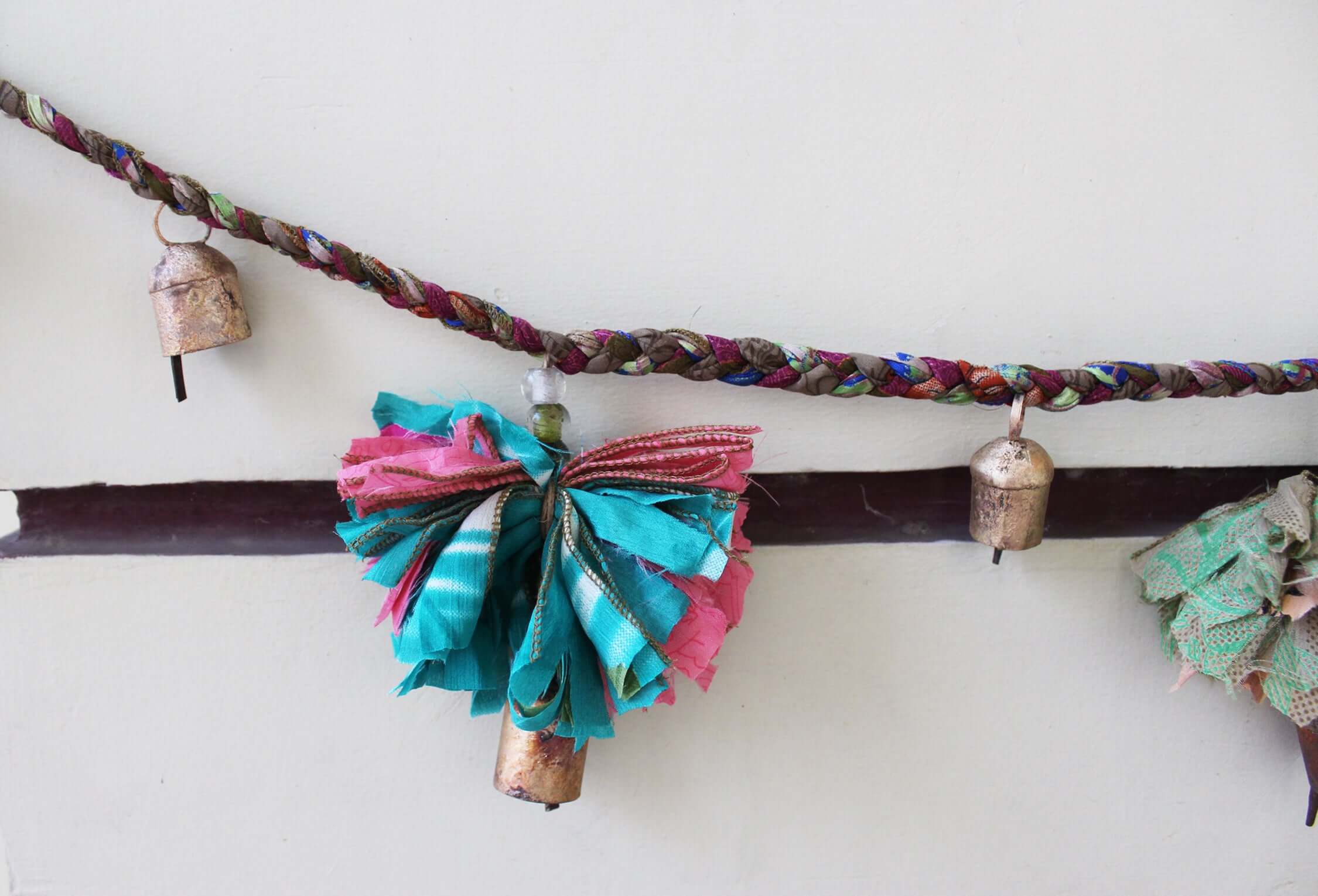 Adorn your space with this 5ft handmade garland of brass bells and glass beads. Perfect for parties and home decoration.