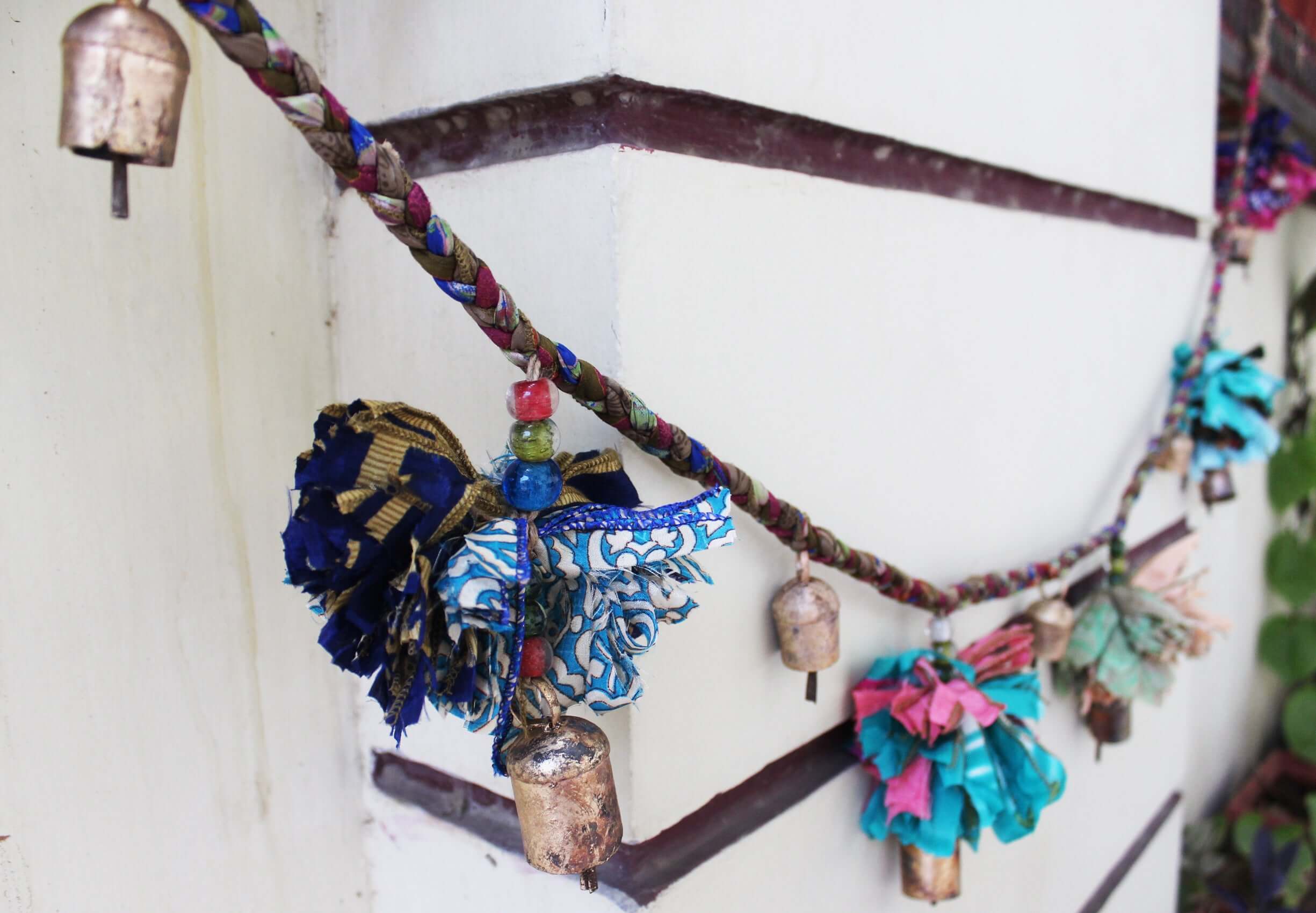 Adorn your space with this 5ft handmade garland of brass bells and glass beads. Perfect for parties and home decoration.
